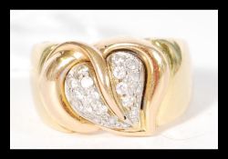 A contemporary hallmarked 18ct gold ring having a sweetheart leaf design with inset white stones.