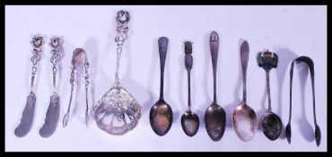 A group of sterling silver and other flatware to include tea spoons, armorial spoons, white metal