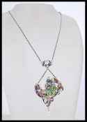 A 20th century silver Art Nouveua necklace in the form of a woman having coloured panels and pearl