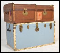 A pair of non matching steamer trunks to include a canvas and cane bound trunk from the early 20th