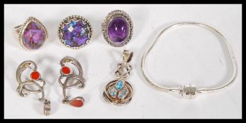 A collection of silver jewellery to include a hammered silver ring with purple agate, silver pendant