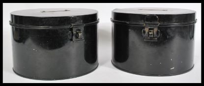 A pair of early 20th Century ebonised metal hinged hat boxes  ( Box ) of circular form. Measures: