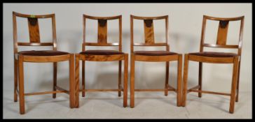 A set of four 20th Century Art Deco dining chairs, drop in seats, slat back raised on turned legs