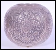 A 20th century Iranian Persian bulbous white metal silver vase with an Islamic bird relief design