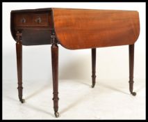 A 19th century Victorian Pembroke mahogany double drop leaf side dining table raised on turned