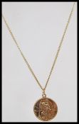 A hallmarked 9ct gold St Christopher's necklace pendant set to a 9k gold necklace chain. Total