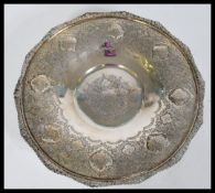 A Persian Islamic display silver white metal bowl with detailed floral engraving and medallions on