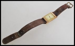 A 9ct gold Buren vintage 20th century tank style wrist watch. The silvered dial having Arabic