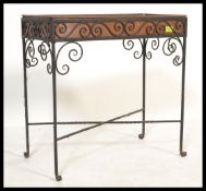A vintage 20th Century copper planter set within an ebonised scroll work iron frame. Measures 62