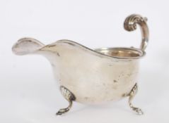 A hallmarked silver sauce boat by S Blanckensee & Son Ltd  raised on tripod feet with gadrooned edge