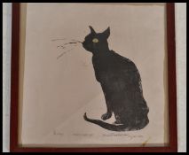 A vintage retro block print on paper featuring a black cat with green eyes in a glazed wooden