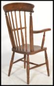 A 19th Century Victorian Windsor spindle back elbow armchair  / chair in beech and elm, raised on