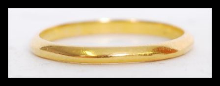 A hallmarked 22ct gold wedding band ring of typical form. Weighs 1.9 grams.