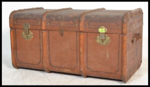 An early 20th Century coach lined canvas and cane bound steamer trunk, brass hinges and lock to