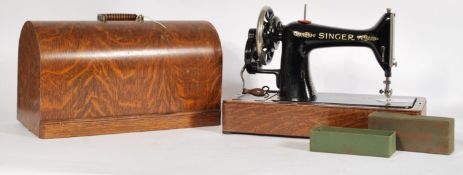 A vintage early 20th century Singer sewing machine complete in oak dome top case. Measures: 32cm