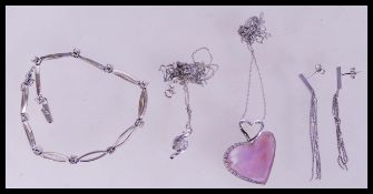 A collection of white gold items to include a ladies bracelet with white stone spacers, a cz cluster