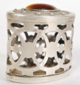A continental silver fret pierced trinket pot having an inset tigers eye cabochon to lid. Silver