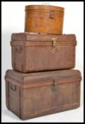 A group of vintage early 20th century tin trunks and luggage to include hat box, a medium trunk