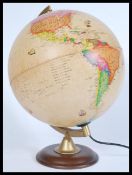 A vintage retro 20th century classical desk top globe lamp raised on a circular wooden base.