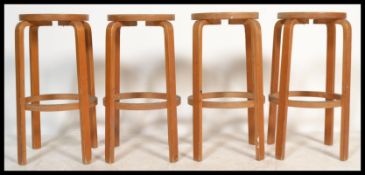 A set of four retro 20th Century bentwood breakfast stools, constructed from marine ply, round panel