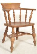 A Victorian beech wood and elm smokers bow armchair with spindle back above solid elm seat on