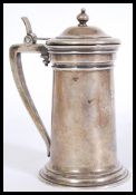 An early 20th German continental white metal silver stein, with engraved monogram, a shaped handle