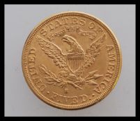 An 1881 American fine dollar coin with an 's' mint mark having a left facing liberty head design and
