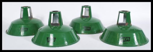 A set of four vintage retro 20th century industrial factory green enamel pendant shades by Revo with