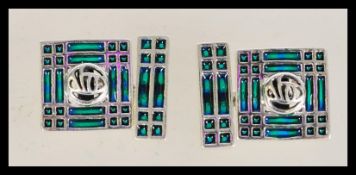 A pair of vintage Plique a Jour cuff links with geometric patterning and green panels, having
