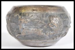 An early 20th century, possibly Lucknow, Indian bowl depicting embossed hunting scene with lions,