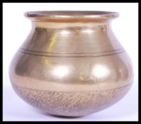 A 19th century Chinese bronze prayer bowl of bulbous form having a tapered neck with flared rim.