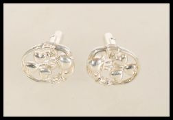 A pair of vintage retro silver cufflinks with a Claddagh design.
