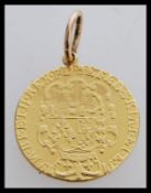A 18th century 1779 George III golden guinea on a pendant setting having a royal coat of arms with