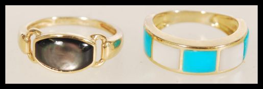 A set of two contemporary 9ct gold Birmingham hallmarked rings. The first having blue and white