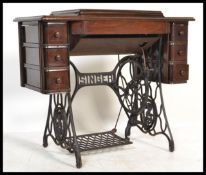 A vintage early 20th Century Edwardian treadle Singer sewing machine on cast metal stand. Measures