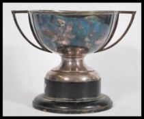 An early 20th Century twin handled silver plated Art Deco Trophy raised on an ebonised socle base.