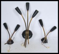 A group of three brass vintage retro 20th century wall lights with tulip sconces and chord pull