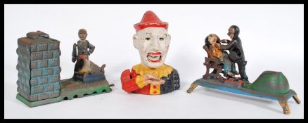 A group of three 20th century vintage novelty mechanical money boxes to include a cast iron clown