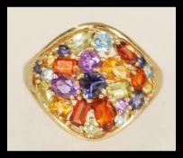 A contemporary 9ct gold multi coloured gem stone ladies ring weighing 2.8 grams, ring size M.5.