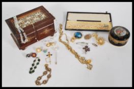A group of vintage costume jewellery to include pearl necklace, silver brooches, etc. held within