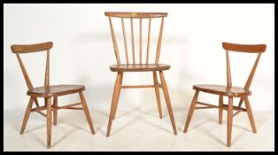 A pair of vintage 20th Century beech and elm Ercol children's stacking chairs together with a single