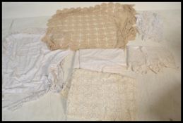 A collection of vintage linens to include, a crochet rectangular table cloth, an initialed bed