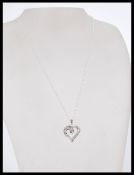 A 20th century 14ct white gold heart shaped diamond pendant necklace weighing 6.1g.