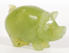 A Chinese carved green jade figurine of a pig having detailed features. Measures: 4cm high x 7cm