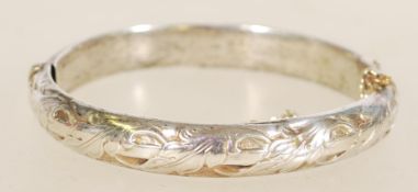 A 20th century stamped 835 silver bracelet bangle with rococo fauna detailing, with a hinge clasp