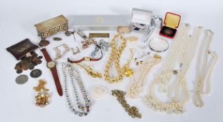 A collection of costume jewellry to include a silver hallmarked money clip, a collection of
