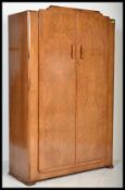 A vintage early 20th century 1930's Art Deco walnut double wardrobe having shaped handles to the