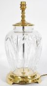 A Waterford crystal table lamp raised on a brass pedestal base and a knopped light stem. Measures:
