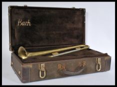 A vintage 20th Century trumpet / bugle with incised ' B&M Champion ' to the horn section, within a