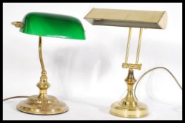 Two vintage 20th century bankers brass desk lamps one having solid brass shade and the other with